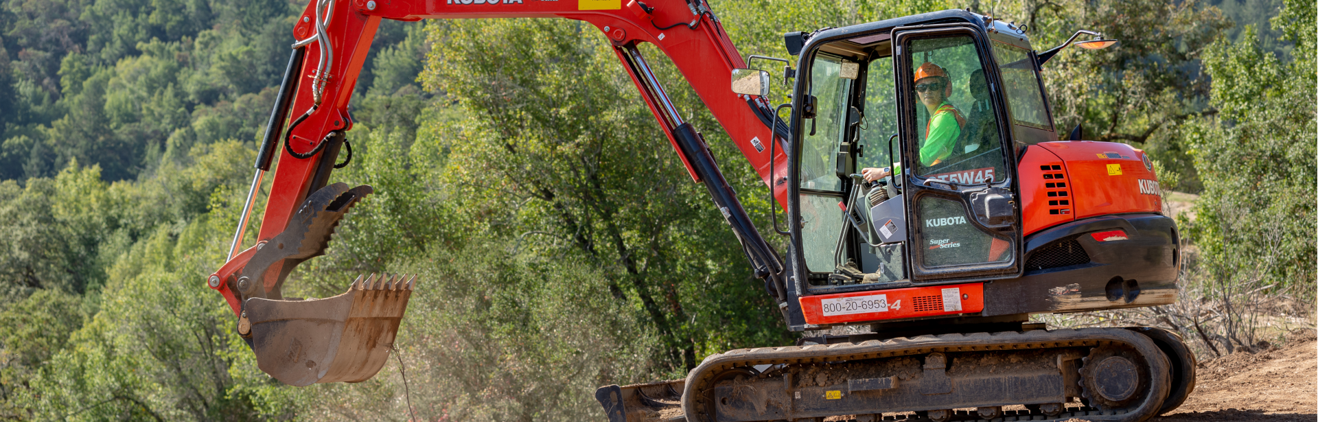Marin County Parks employee operating a backhoe in Marin County Open Space